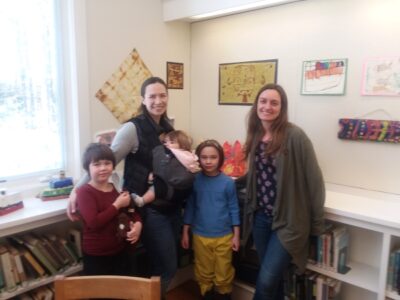 Three children with to adults in the art exhibit room at Friend Memorial Library