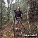 Michael Kahn with camera on tripod on Babson Island