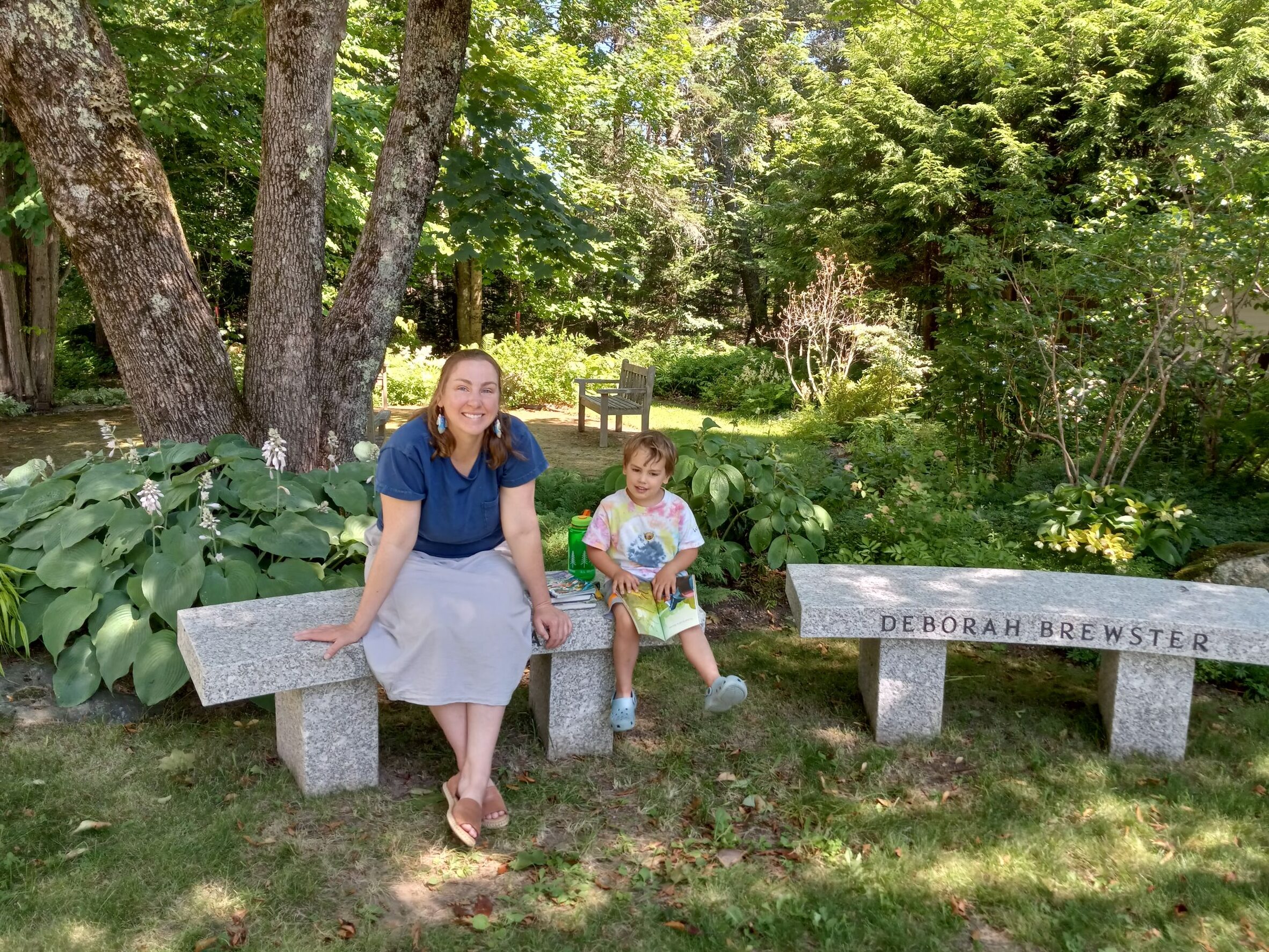 Jenny Smick (Mother) and Wick Hardy (son) sitting on the granite benches at Friend Memorial Library