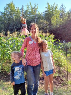 Dolphin with Watson and Fisher at the Brooklin Community Garden Party 2022 with Sally Scarecrow in the back ground